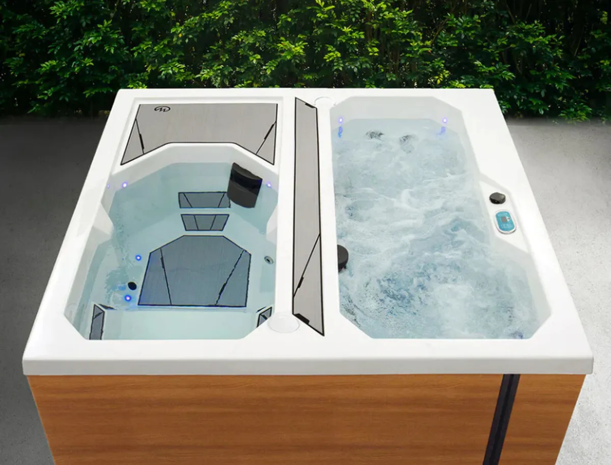 An inviting hot tub set amidst lush greenery, with bubbling water jets and ample space for relaxation. The scene exudes tranquility, suggesting a private spa-like retreat integrated into the natural surroundings.